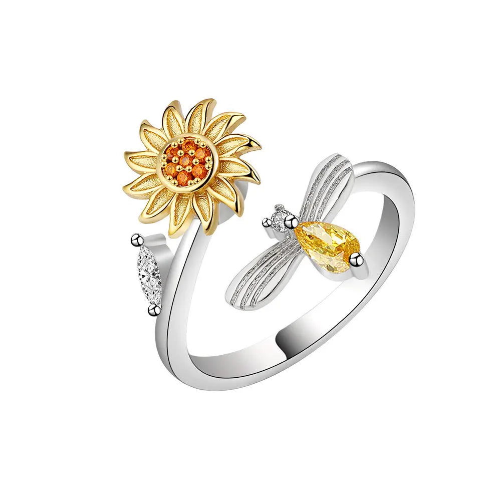 Anillo giratorio de abeja y flor