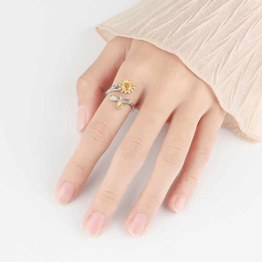 Anillo giratorio de abeja y flor