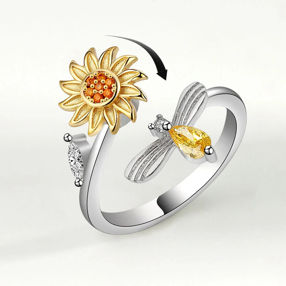 Anillo giratorio de abeja y flor