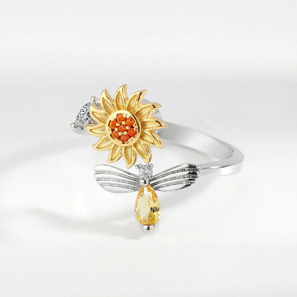 Anillo giratorio de abeja y flor