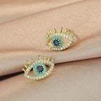 Pendientes de botón con ojo azul y strass