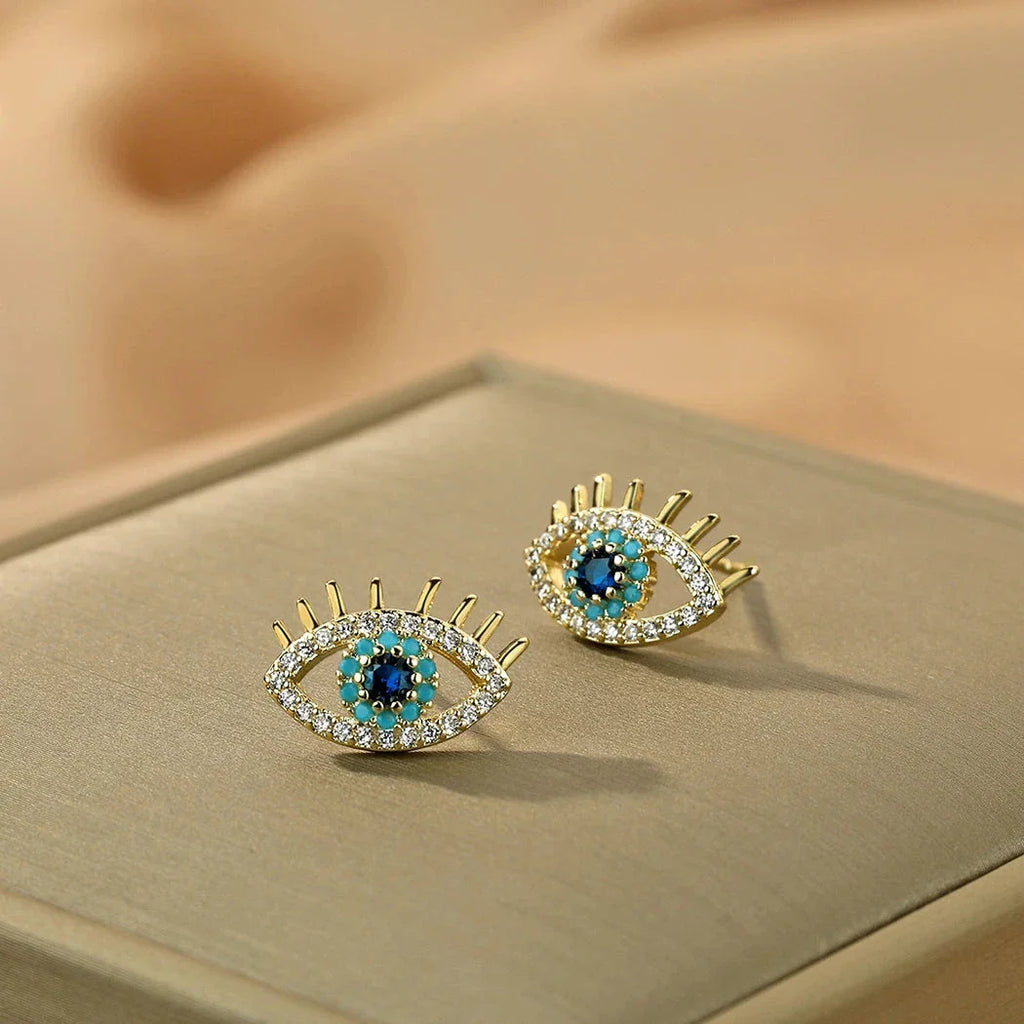 Pendientes de botón con ojo azul y strass