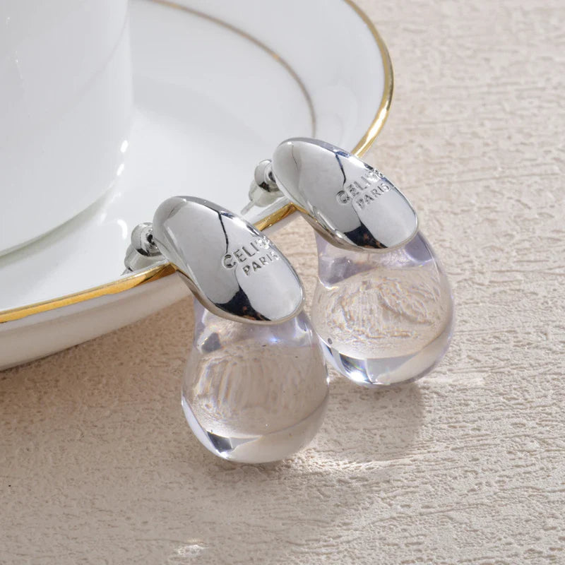 Aretes de botón gota de agua transparente en plata