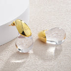Aretes de botón gota de agua transparente en oro