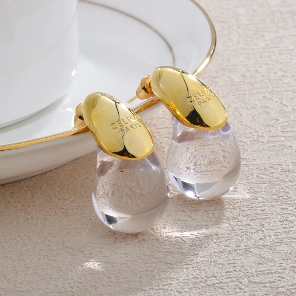 Aretes de botón gota de agua transparente en oro
