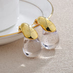 Aretes de botón gota de agua transparente en oro