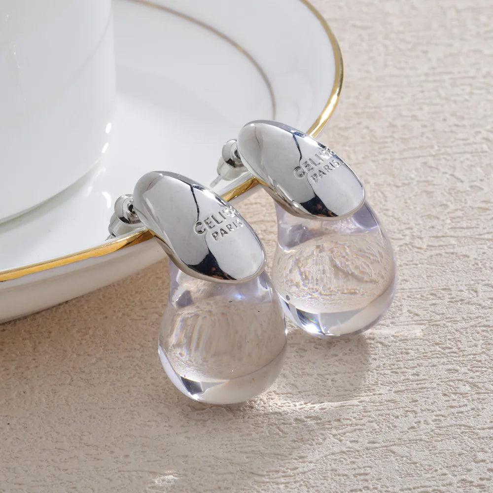 Aretes de botón gota de agua transparente en plata