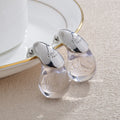 Aretes de botón gota de agua transparente en plata
