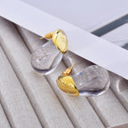 Aretes de botón gota de agua transparente en oro