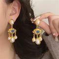 Pendientes Colgantes Ojo Azul y Perlas en oro