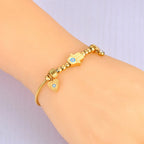 Pulsera de Protección con Mano de Fátima y Ojo Azul en oro