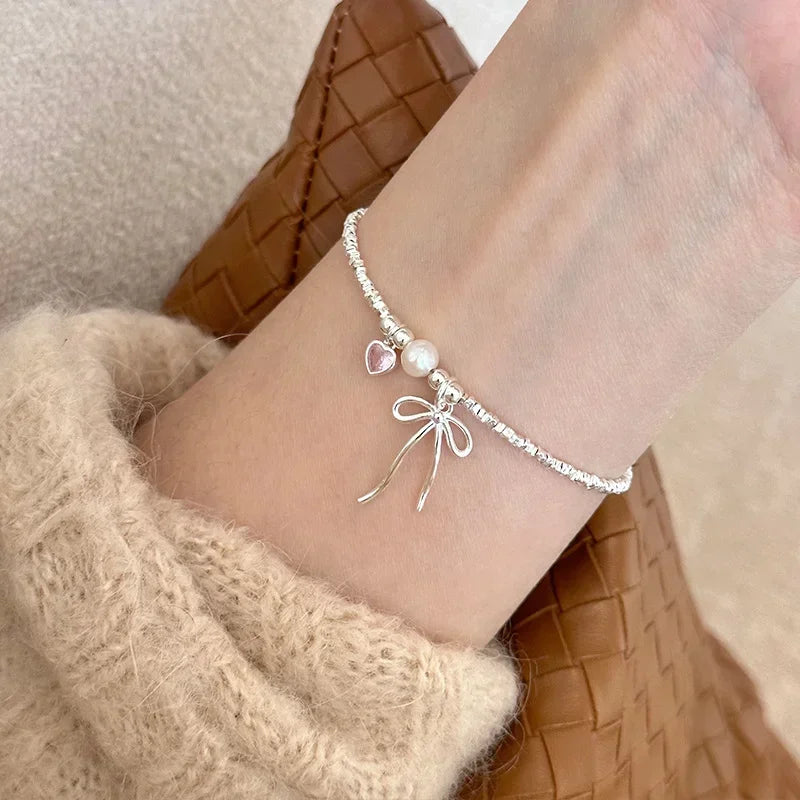 Pulsera Gourmette Nudo de Mariposa y Perla