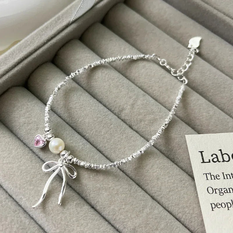 Pulsera Gourmette Nudo de Mariposa y Perla
