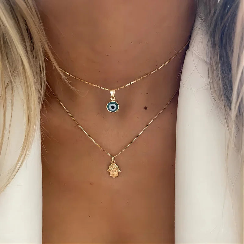 Collar doble con colgante Ojo Azul Turco y Mano de Fátima en oro