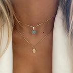 Collar doble con colgante Ojo Azul Turco y Mano de Fátima en oro