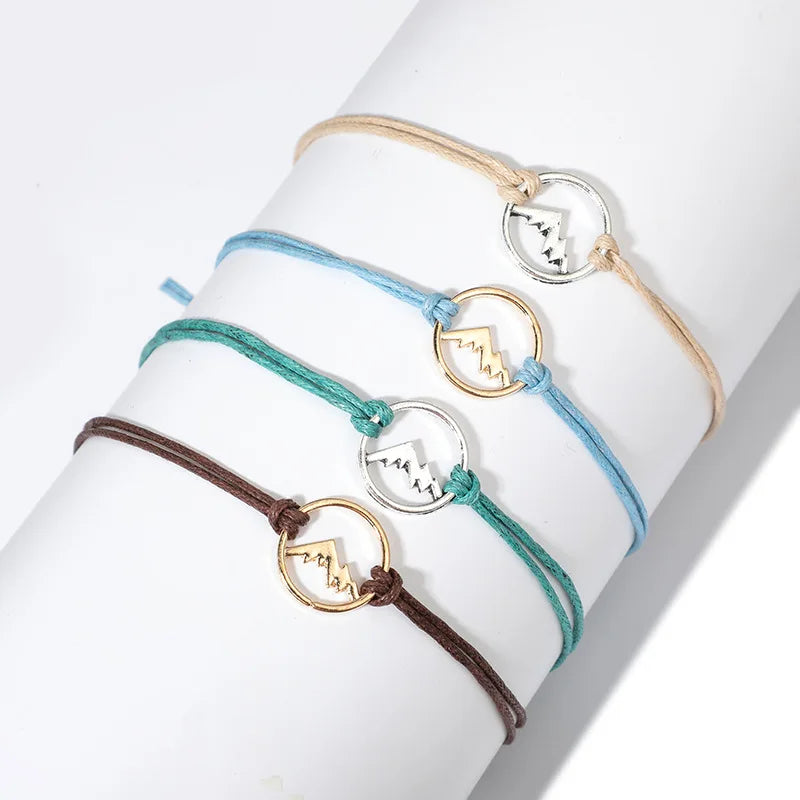 Lote de 4 pulseras de cuerda con colgante redondo de montaña