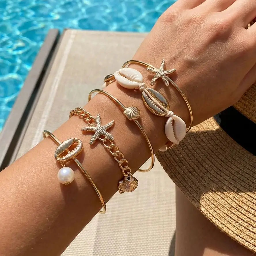 Set de 5 pulseras de concha y estrella doradas